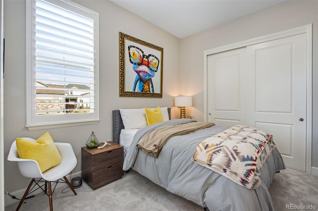 bedroom with light carpet and a closet
