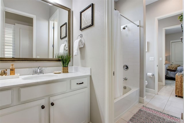 ensuite bathroom with toilet, vanity, shower / bath combo, tile patterned flooring, and connected bathroom