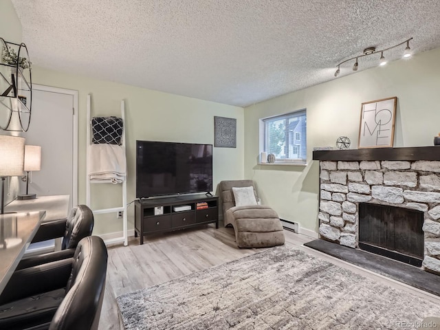 4068 S Atchison Way Unit 101, Aurora, CO 80014 - living room with wood finished floors, a textured ceiling, an office area, and a fireplace