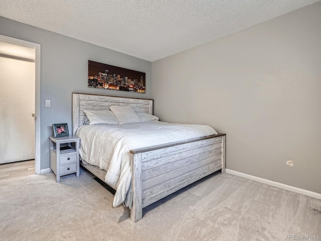4068 S Atchison Way Unit 101, Aurora, CO 80014 - bedroom featuring carpet and a textured ceiling