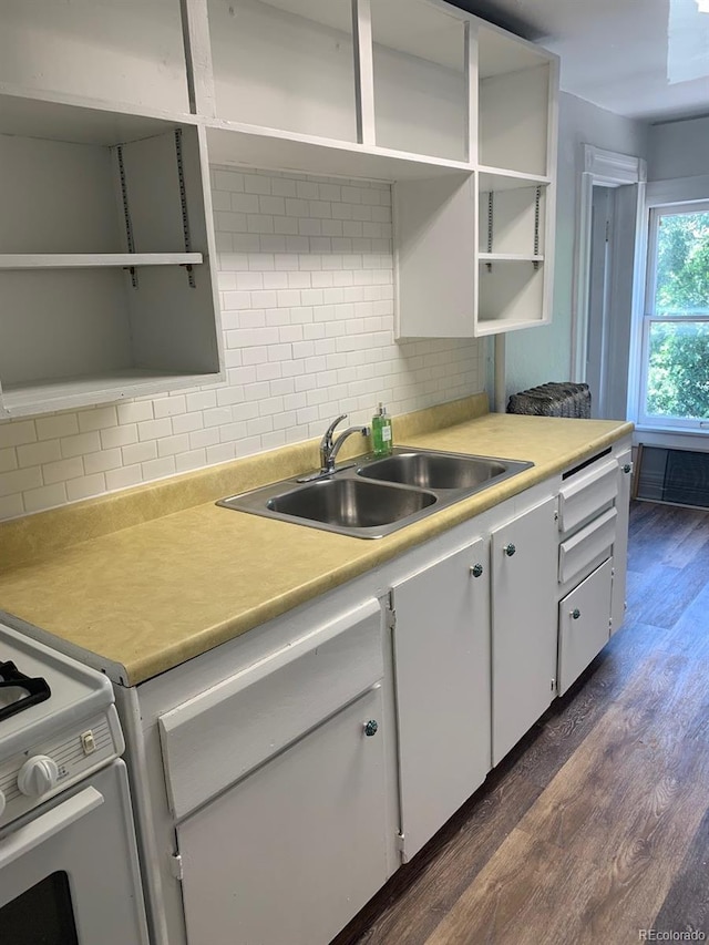 kitchen featuring a sink, white cabinetry, light countertops, backsplash, and open shelves