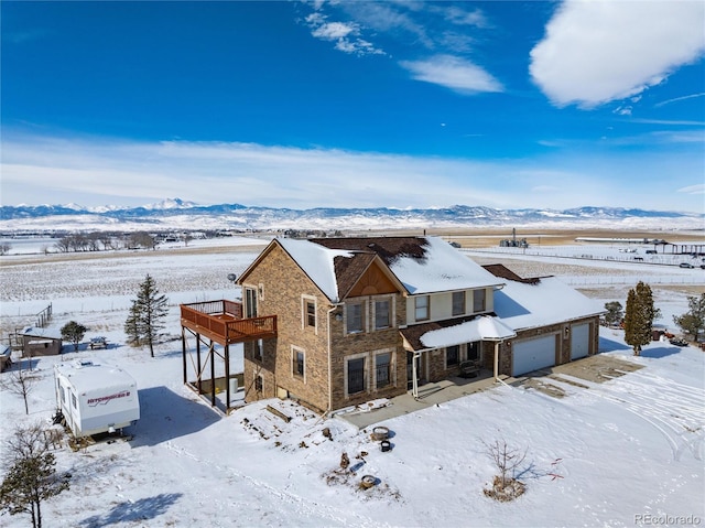 snowy aerial view featuring a mountain view