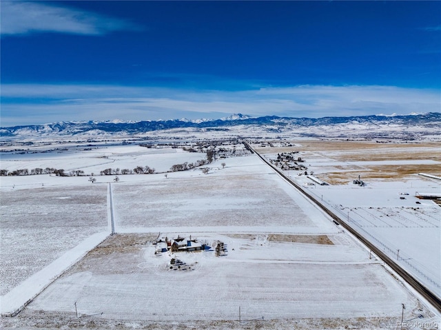snowy aerial view with a mountain view