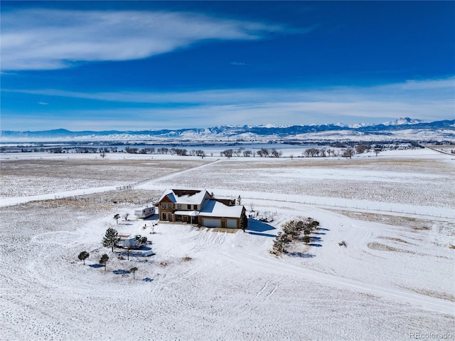 snowy aerial view with a mountain view