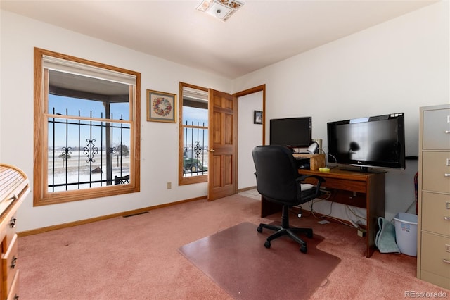 home office featuring light carpet, baseboards, and visible vents
