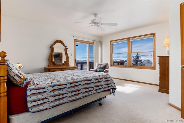 bedroom with access to exterior, light colored carpet, baseboards, and a ceiling fan