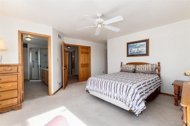 bedroom featuring light carpet, visible vents, baseboards, ensuite bath, and ceiling fan
