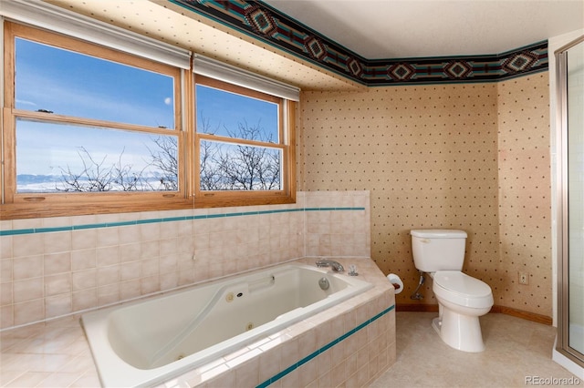 full bathroom featuring a garden tub, toilet, and baseboards