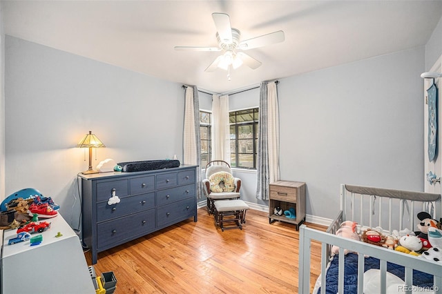 bedroom with baseboards, ceiling fan, and light wood-style floors