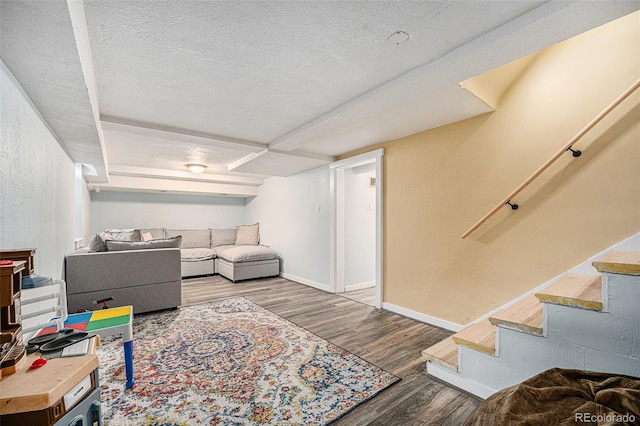 living area with a textured ceiling, stairway, wood finished floors, and baseboards