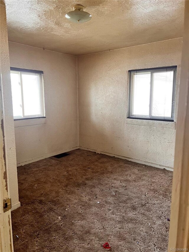 empty room with a textured ceiling