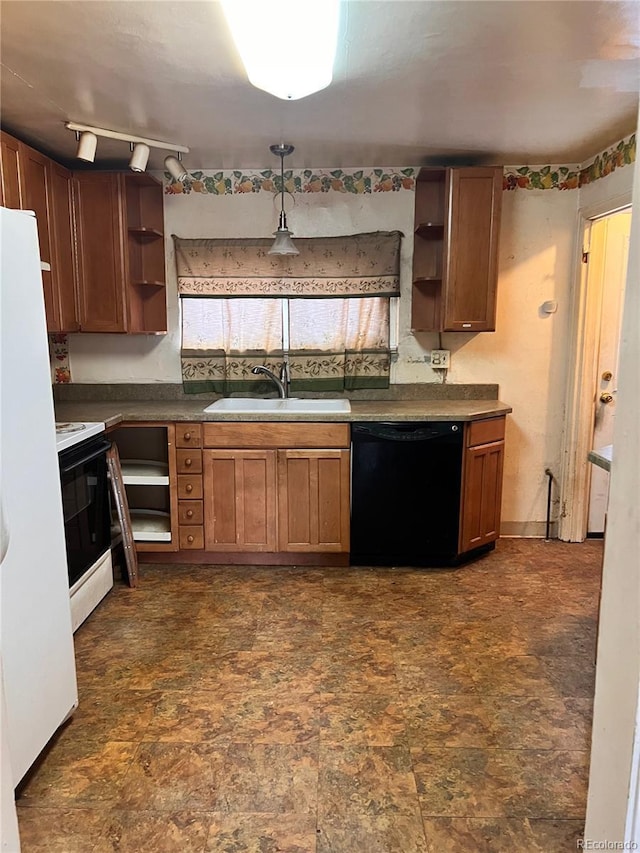 kitchen featuring sink, white appliances, and decorative light fixtures