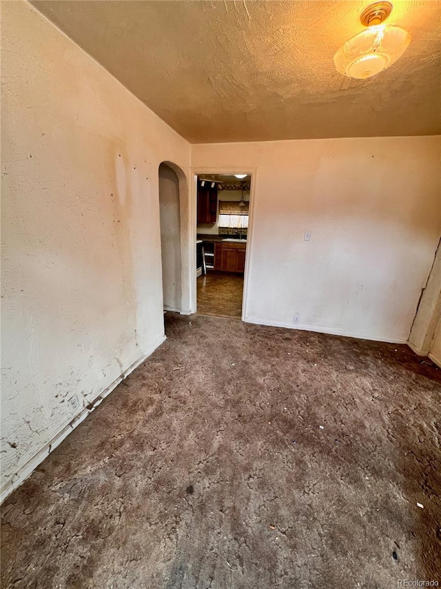 spare room with a textured ceiling