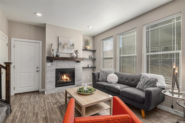 living room featuring a fireplace, hardwood / wood-style floors, and a textured ceiling