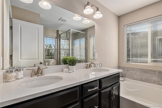 bathroom featuring vanity, a textured ceiling, and plus walk in shower