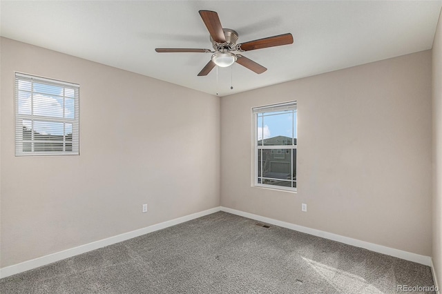 empty room featuring carpet, plenty of natural light, and ceiling fan