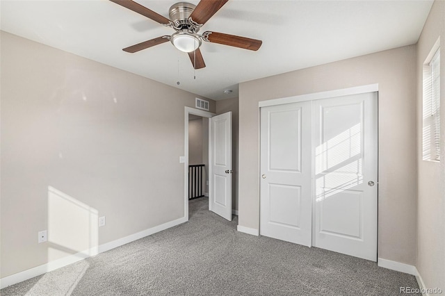 unfurnished bedroom with ceiling fan, a closet, and carpet