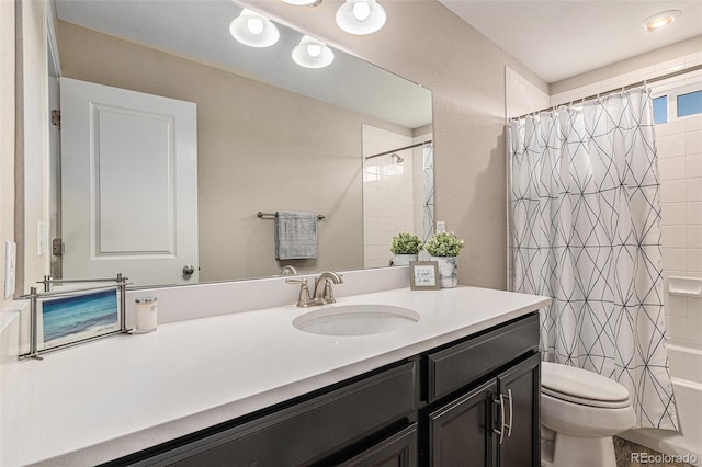 full bathroom featuring shower / tub combo with curtain, vanity, and toilet