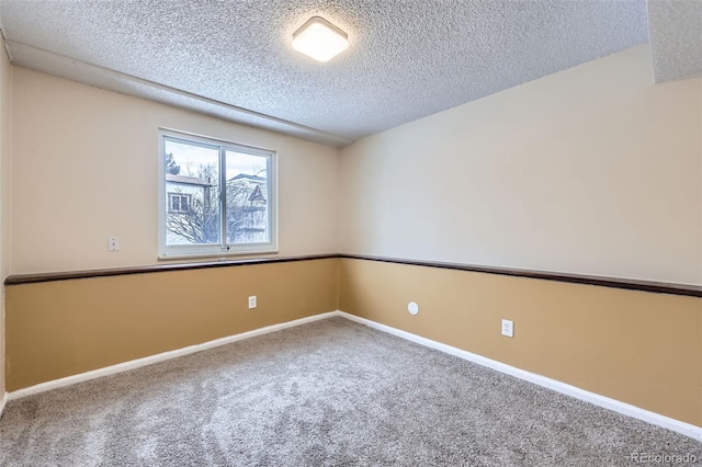 unfurnished room featuring a textured ceiling and carpet flooring