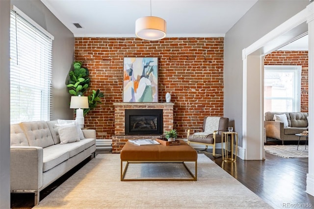 321 S Emerson St, Denver, CO 80209 - living area with brick wall, wood finished floors, a fireplace, and ornamental molding