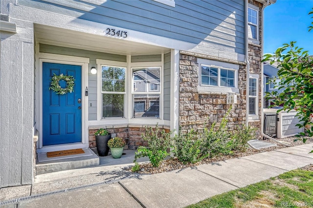 property entrance with stone siding