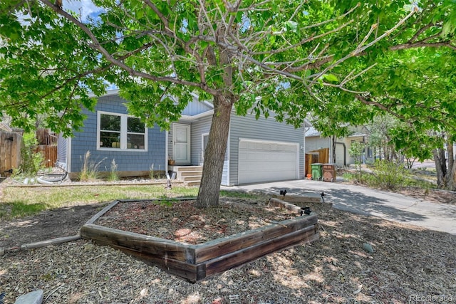 972 Columbine Ave, Colorado Springs, CO 80904 - view of property hidden behind natural elements with concrete driveway and a garage