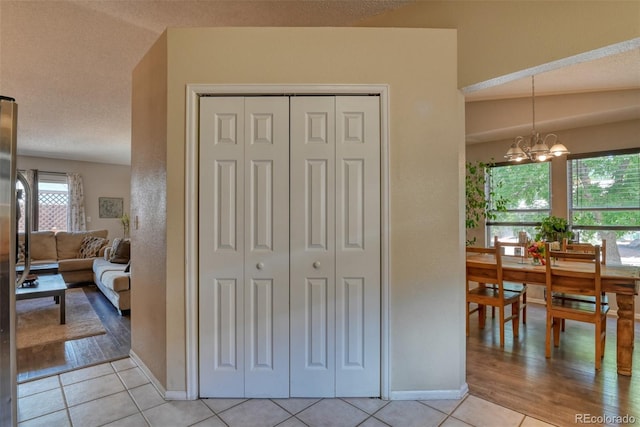 972 Columbine Ave, Colorado Springs, CO 80904 - corridor featuring a chandelier and light tile patterned flooring