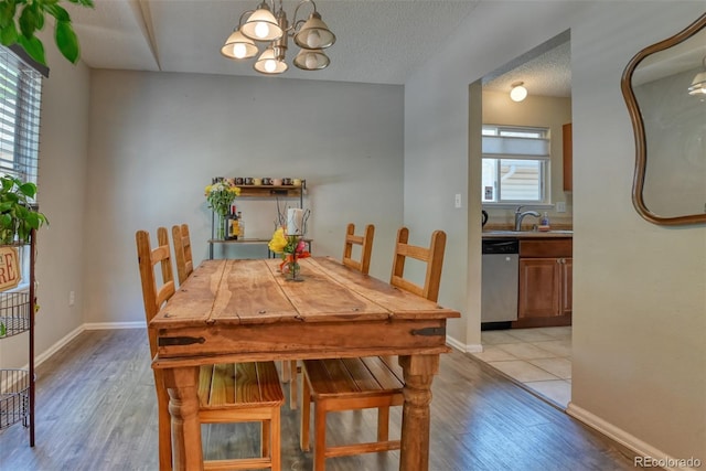 972 Columbine Ave, Colorado Springs, CO 80904 - dining space featuring a chandelier and light wood-style floors