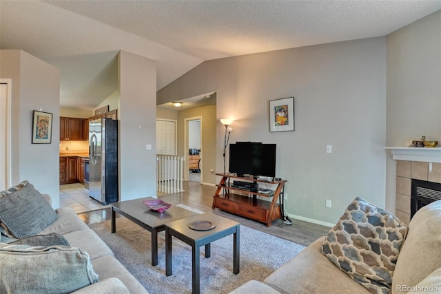972 Columbine Ave, Colorado Springs, CO 80904 - living area with vaulted ceiling, light wood-style floors, and a fireplace