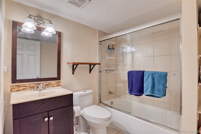 972 Columbine Ave, Colorado Springs, CO 80904 - bathroom featuring a textured wall, vanity, enclosed tub / shower combo, and a textured ceiling