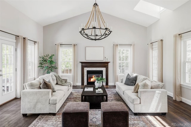 8739 E 23rd Ave, Denver, CO 80238 - living area featuring a chandelier, dark wood-type flooring, high vaulted ceiling, and a glass covered fireplace