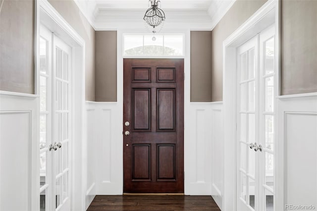 8739 E 23rd Ave, Denver, CO 80238 - entryway featuring a decorative wall, a wainscoted wall, ornamental molding, and dark wood-style flooring