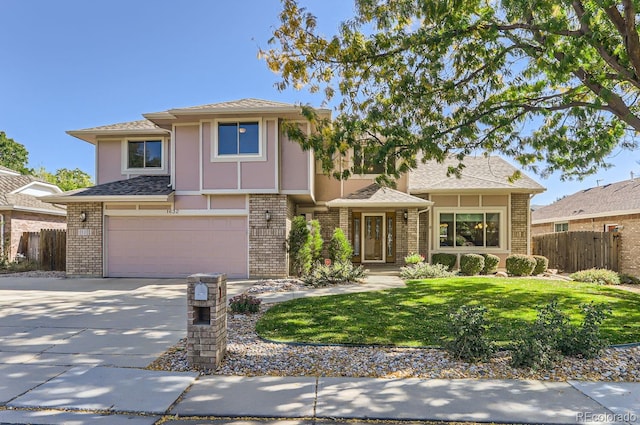 view of front of property with a garage and a front yard