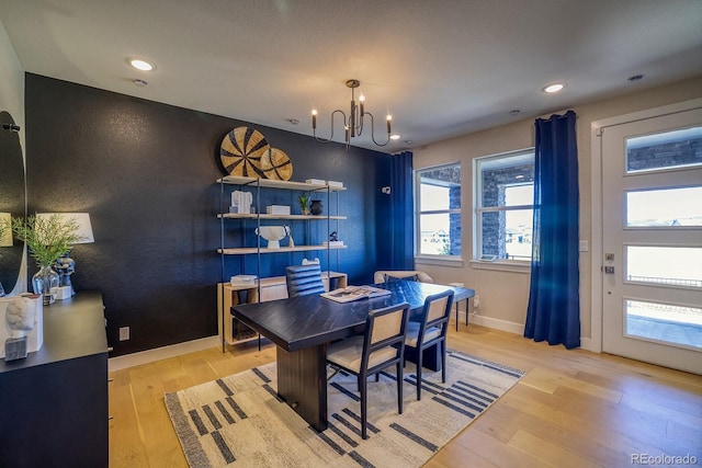 dining room featuring a chandelier, wood finished floors, recessed lighting, and baseboards