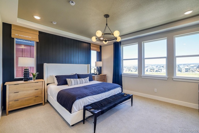 bedroom featuring baseboards, light colored carpet, a chandelier, a textured ceiling, and recessed lighting