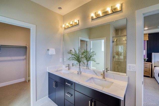 full bathroom featuring tiled shower, ensuite bath, baseboards, and double vanity