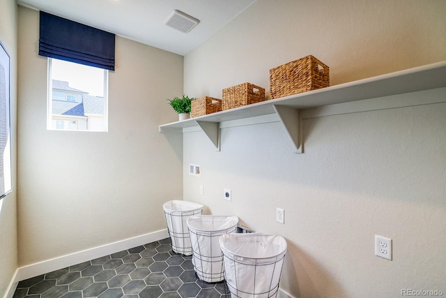 washroom featuring washer hookup, electric dryer hookup, baseboards, and dark tile patterned flooring