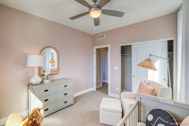 bedroom with light carpet, baseboards, a ceiling fan, and a closet