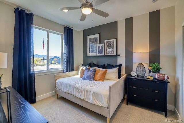 bedroom with baseboards, light colored carpet, and a ceiling fan