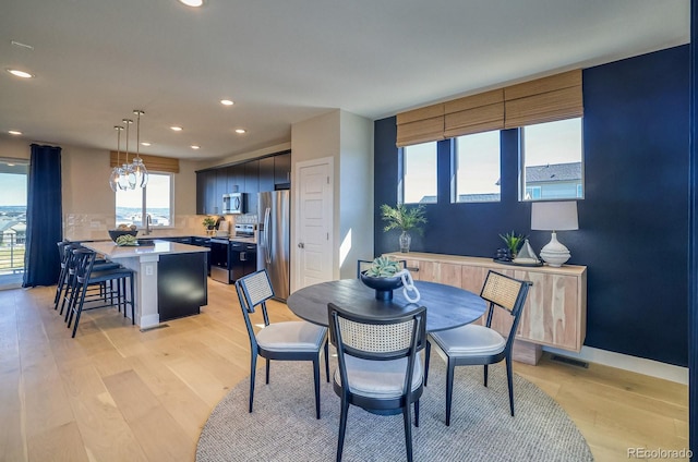 dining space with recessed lighting and light wood-style floors