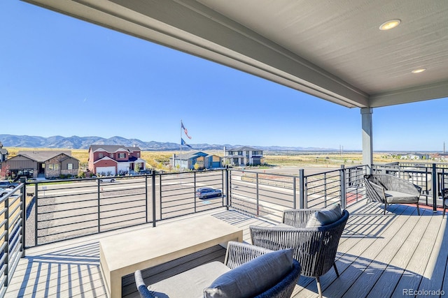 deck with a mountain view and a residential view