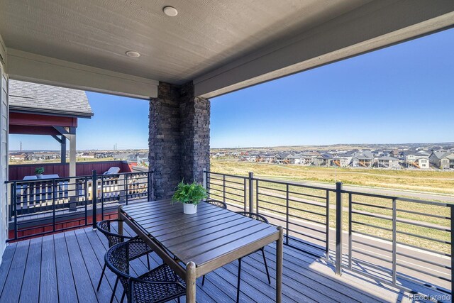 deck featuring a residential view and outdoor dining space
