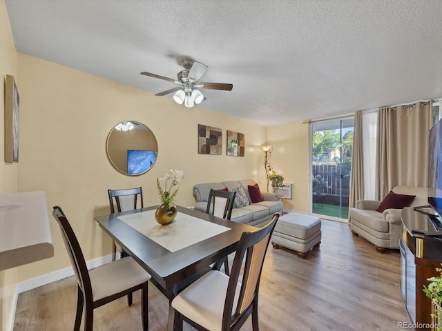 dining room with ceiling fan, a textured ceiling, and light hardwood / wood-style flooring