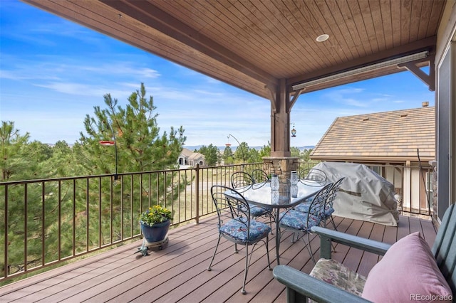 wooden terrace featuring outdoor dining area