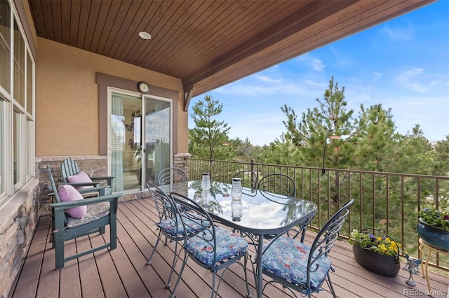 wooden terrace with outdoor dining space