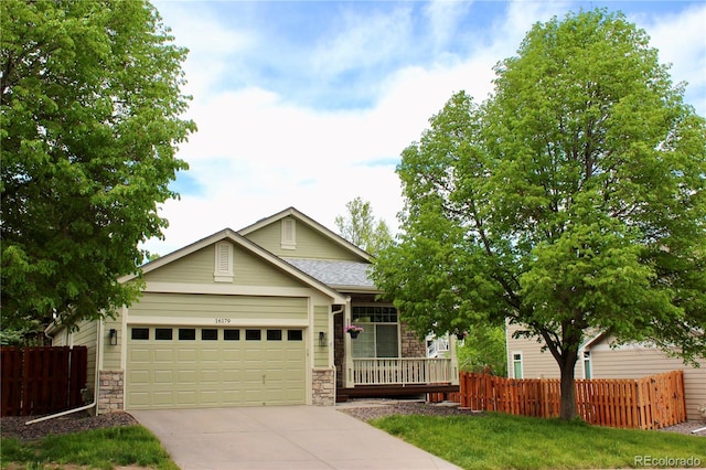 16179 W 70th Pl, Arvada, CO 80007 - ranch-style house featuring stone siding, an attached garage, and fence