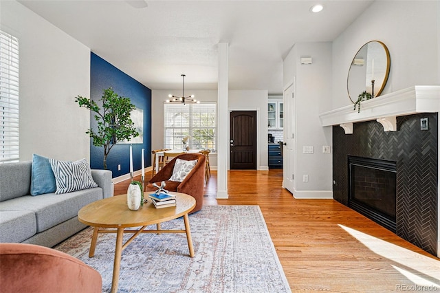 1063 Roslyn Ct, Denver, CO 80230 - living area with light wood-style flooring, a chandelier, baseboards, a tile fireplace, and recessed lighting