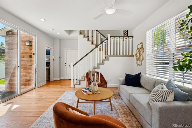 1063 Roslyn Ct, Denver, CO 80230 - living area with light wood-style floors, stairs, a ceiling fan, baseboards, and recessed lighting