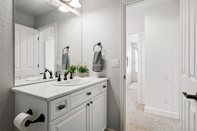 1063 Roslyn Ct, Denver, CO 80230 - bathroom featuring vanity, a textured wall, and baseboards