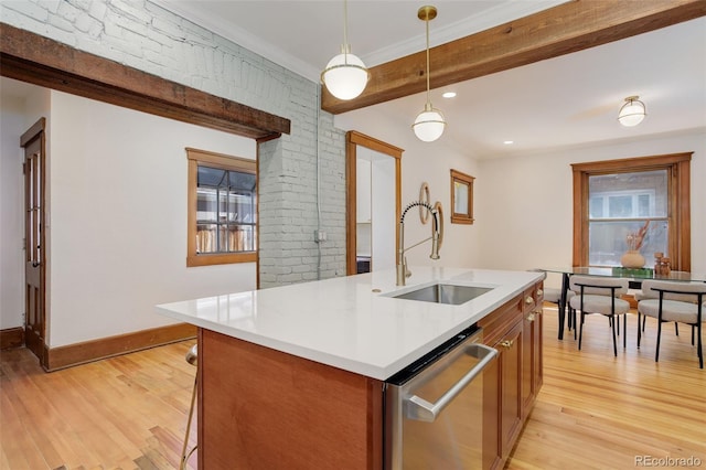 kitchen featuring a sink, dishwasher, light wood finished floors, brown cabinetry, and beamed ceiling